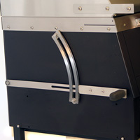 The lever on the side raises and lowers the charcoal fire inside the grill