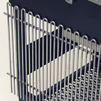 The cooking grate hangs from two hooks on the side of the grill when not in use.