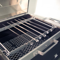 The custom skewer rack replaces the cooking grate